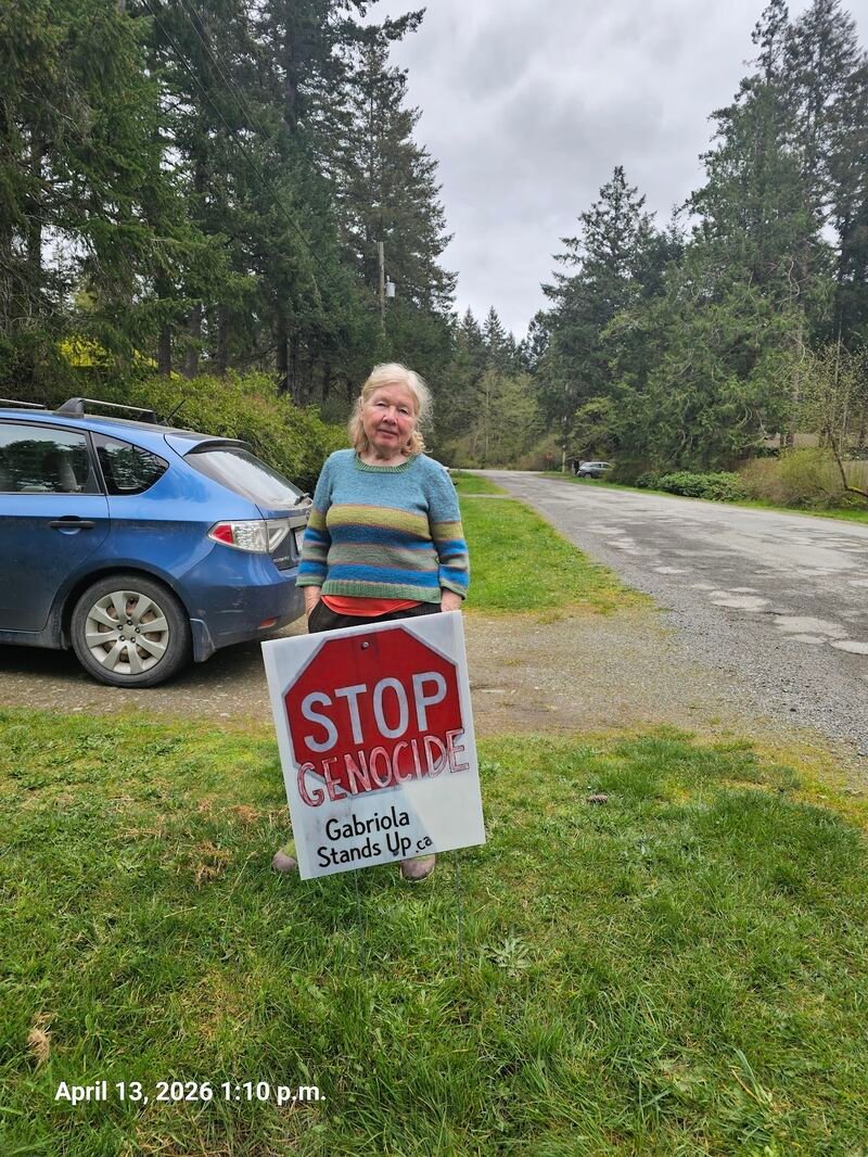 Anna with her Stop Genocide sign on McClay Road, Gabriola