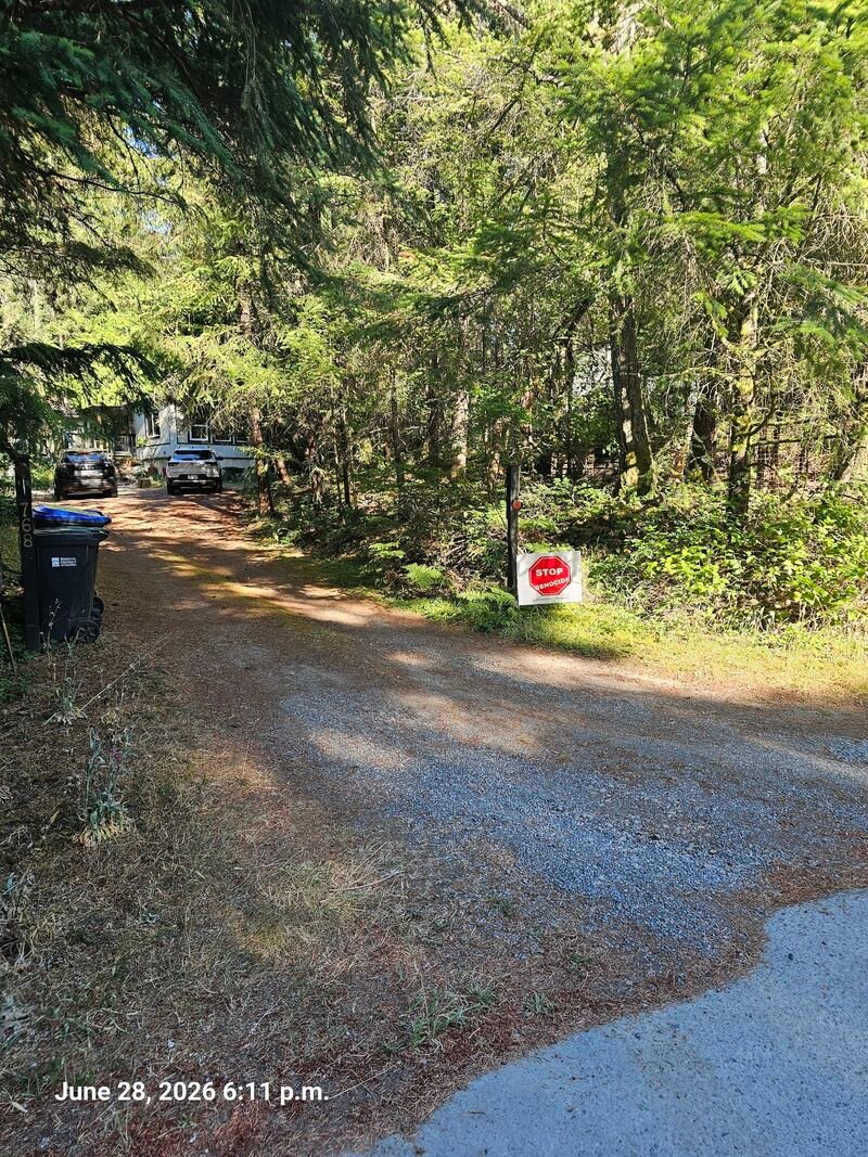 Bernard's Stop Genocide sign on Ross Way, Gabriola
