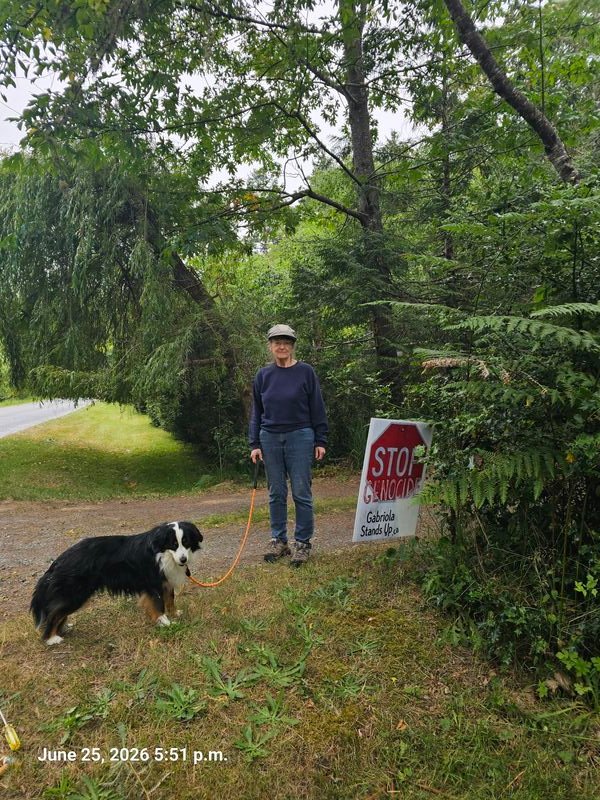 Chris with his Stop Genocide sign on Spruce Road, Gabriola