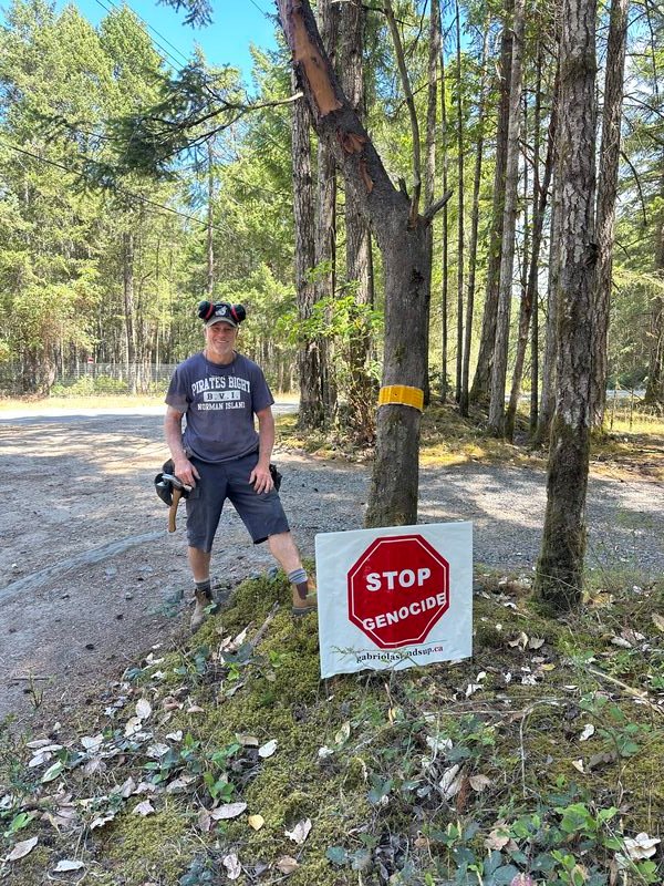 Chris's Stop Genocide sign on Taylor Bay Road, Gabriola