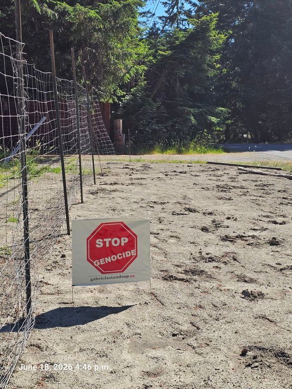 Colin and Carol's Stop Genocide sign on Browns Way, Gabriola