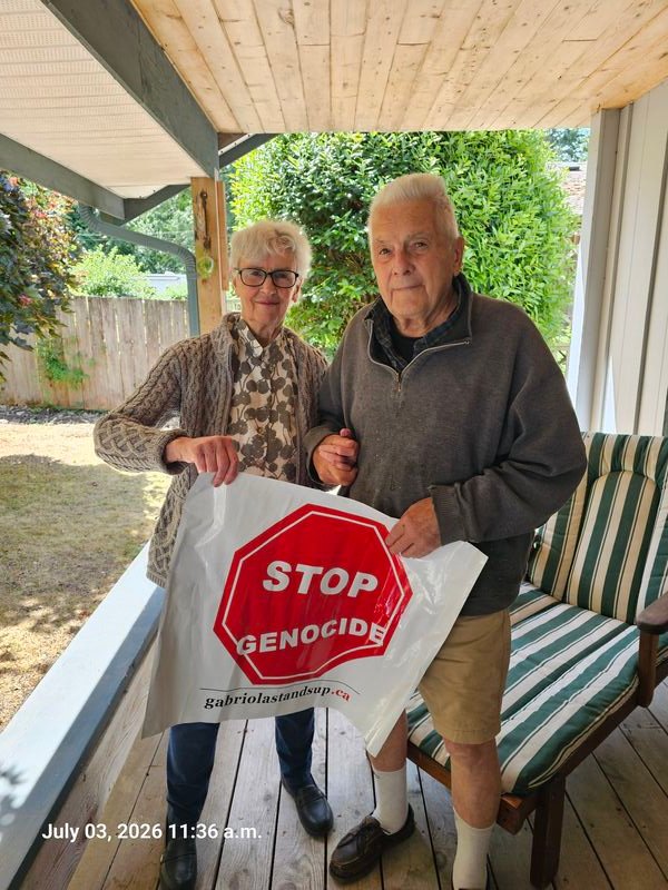 Erik and Catherine's Stop Genocide sign on Rollo Road, Gabriola