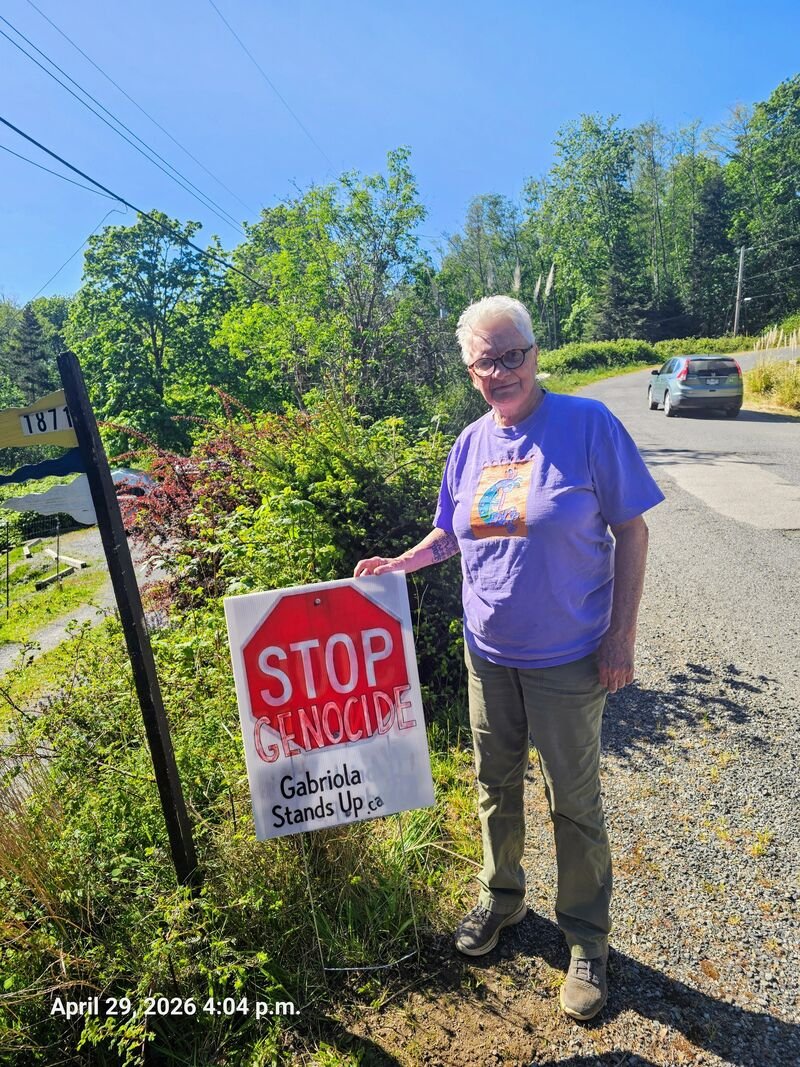 Jacqui with her Stop Genocide sign on Garland Drive, Gabriola