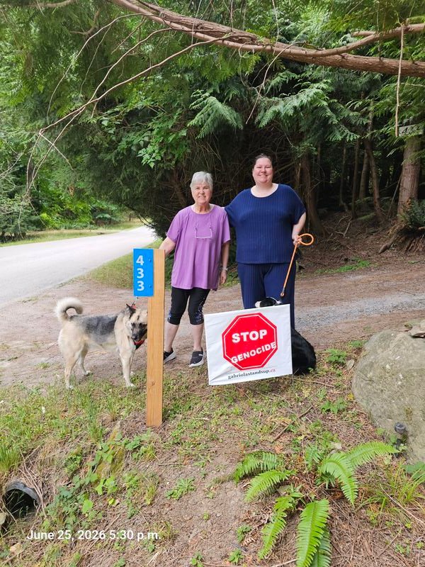 Janet & Rebecca with their Stop Genocide sign on Spruce Road, Gabriola