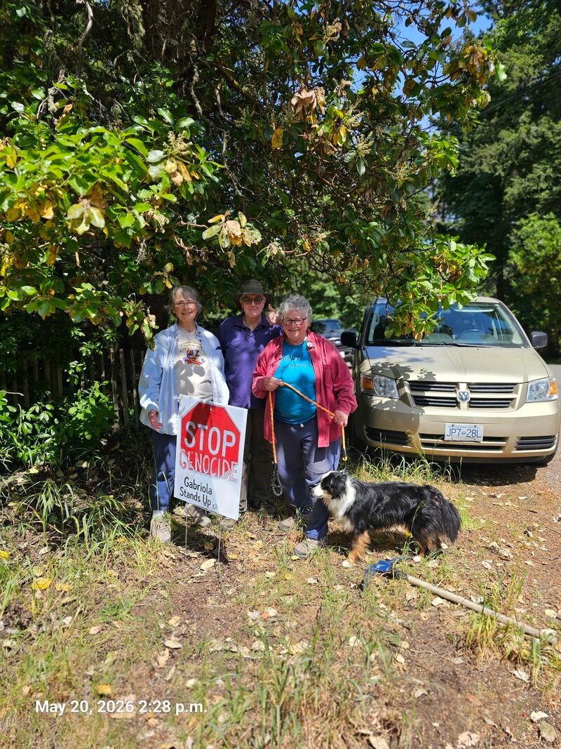 Jewel and Margo with their Stop Genocide sign on Blueback Drive, Gabriola