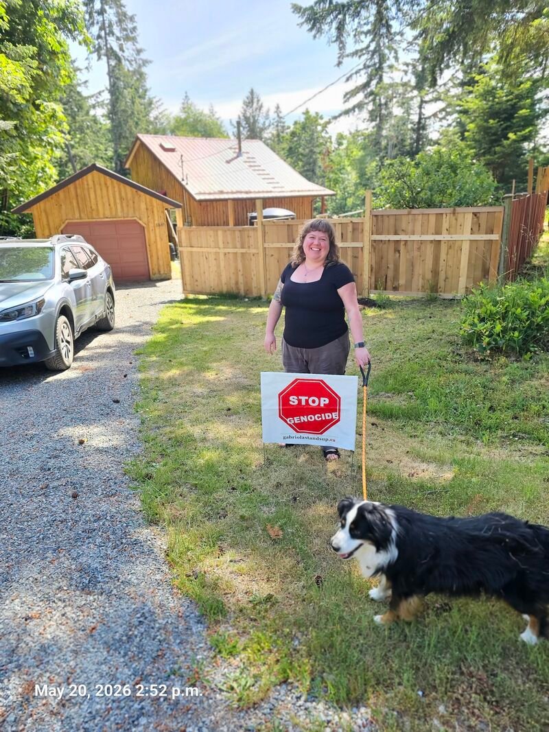 Katherine with her Stop Genocide sign on Mander Drive, Gabriola