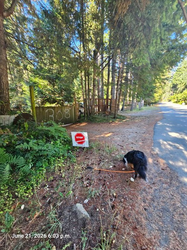 Kathryn's Stop Genocide sign on Malaspina Drive, Gabriola