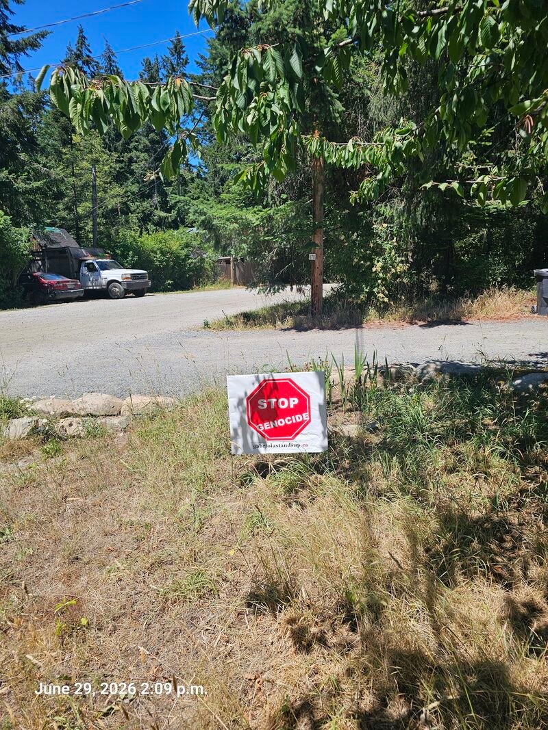 Kelly's Stop Genocide sign on Gallagher Road, Gabriola