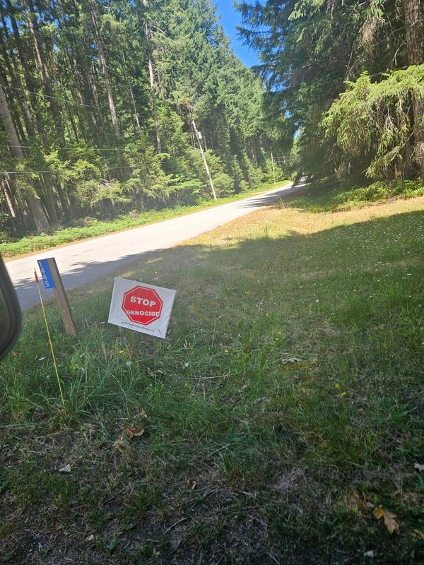 Kim and Tom's Stop Genocide sign on Hess Road, Gabriola