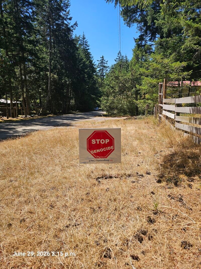 Leona's Stop Genocide sign on Gallagher Road, Gabriola