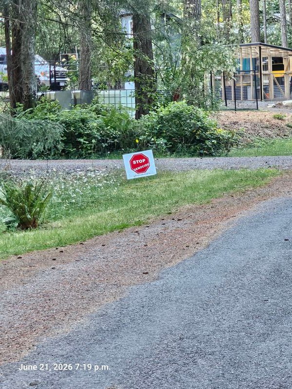 Lynn's Stop Genocide sign on Violet Crescent, Gabriola