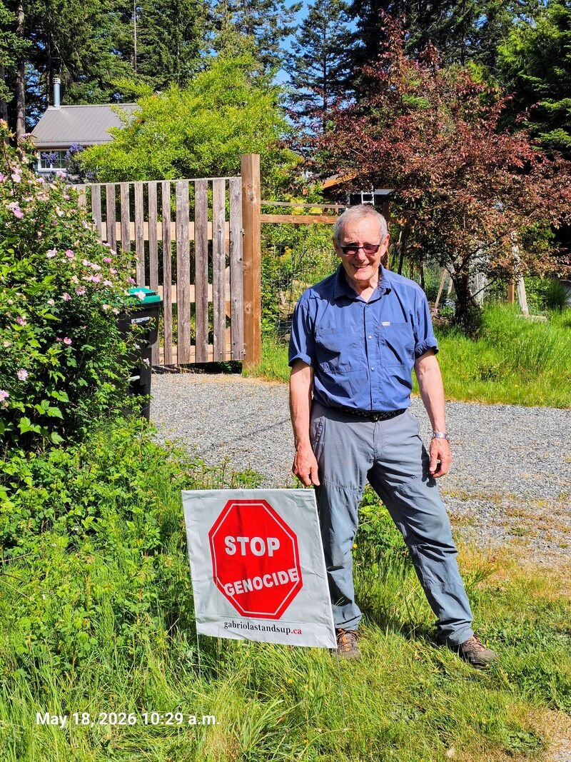 Nigel Daggoo with his Stop Genocide sign on Gabriola Island