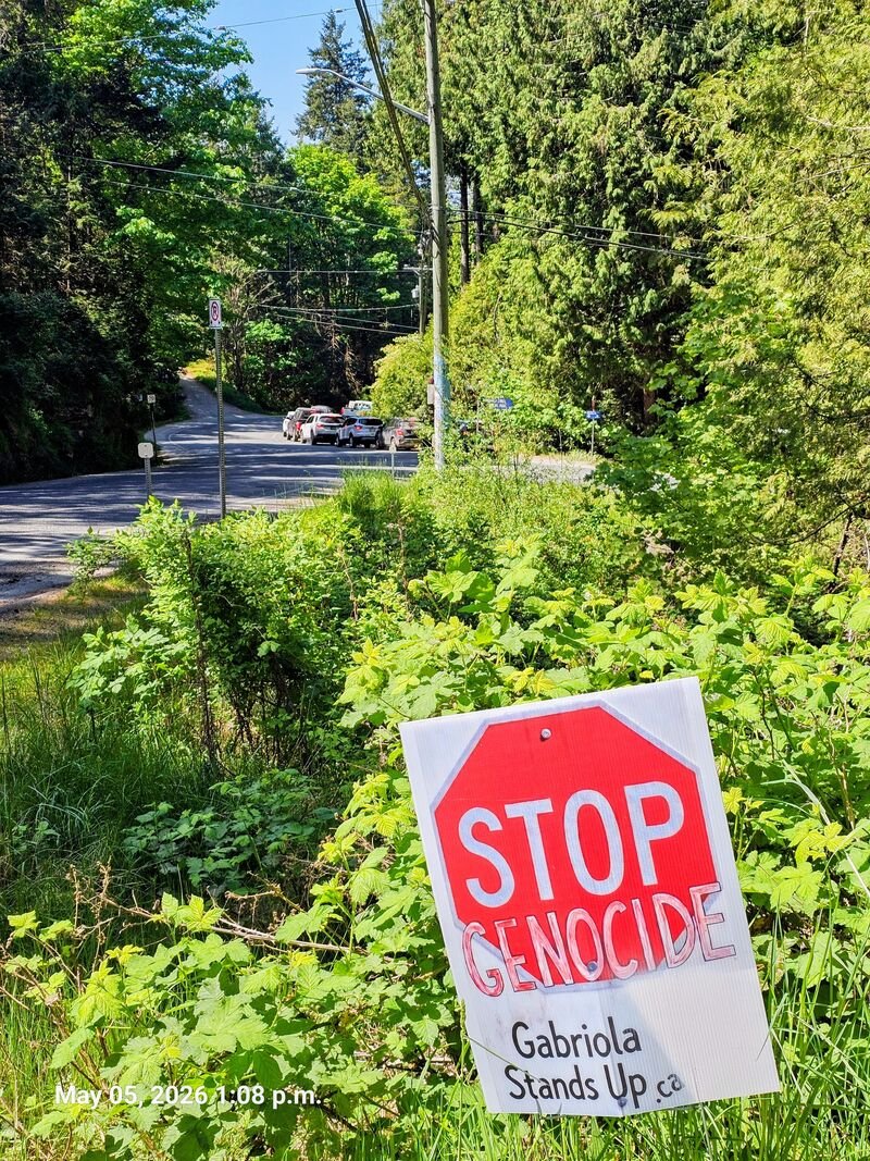 Stop Genocide sign at North Road and Taylor Bay Road, Gabriola