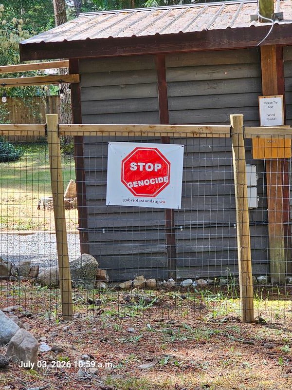 Stop Genocide sign at the corner of Gallagher and Little Roads, Gabriola