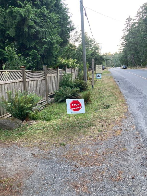 Roman's Stop Genocide sign on South Road, Gabriola