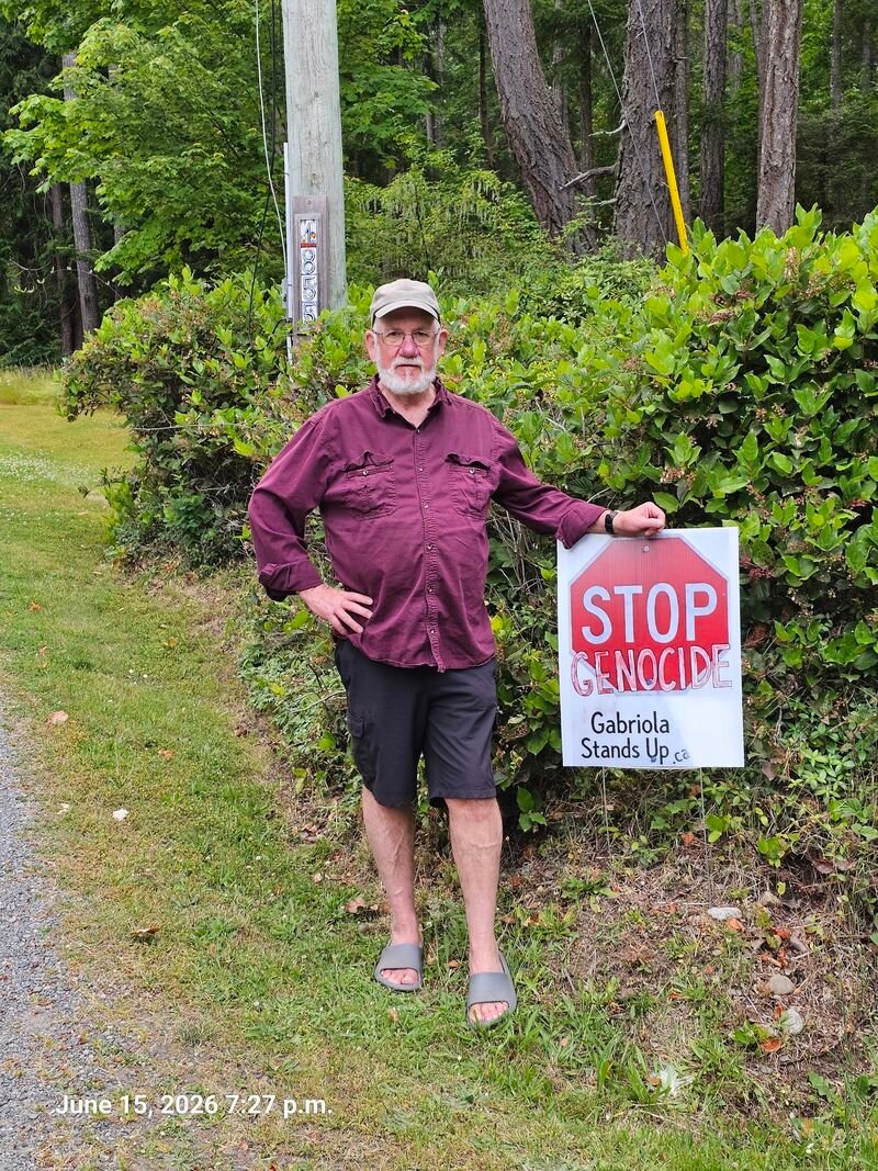 Ron with his Stop Genocide sign on Degnan Road South, Gabriola