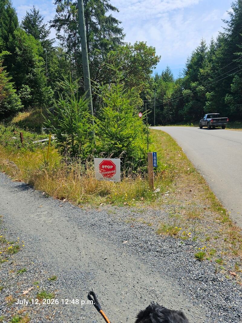 Ron's Stop Genocide sign on Seymour Road, Gabriola