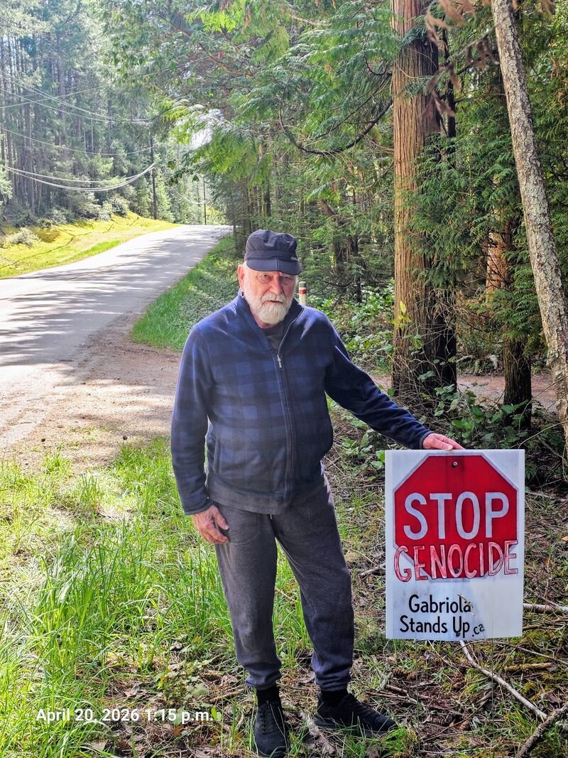 Brian with his Stop Genocide sign on Taylor Bay Road, Gabriola