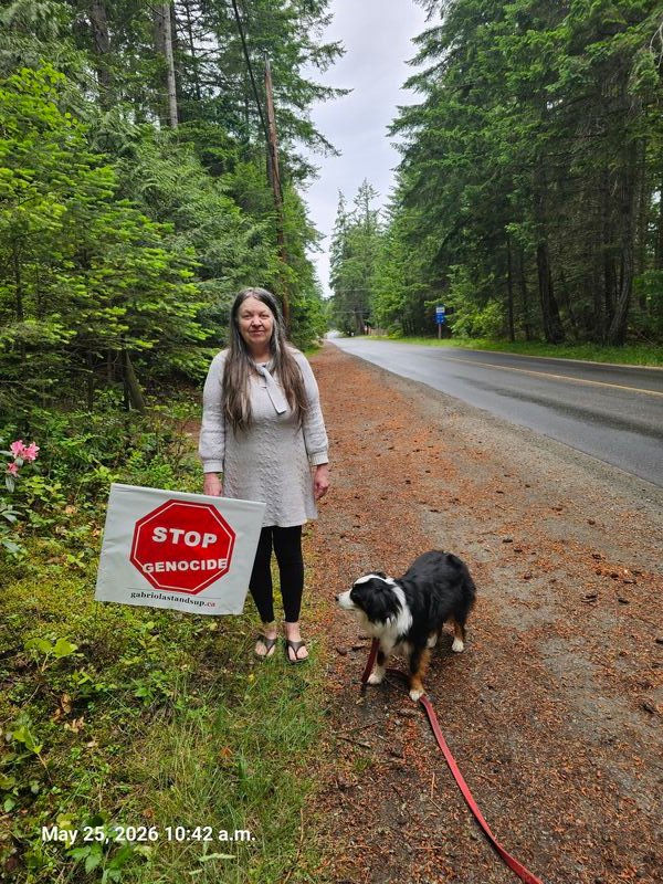 Shannon with her Stop Genocide sign on North Road, Gabriola