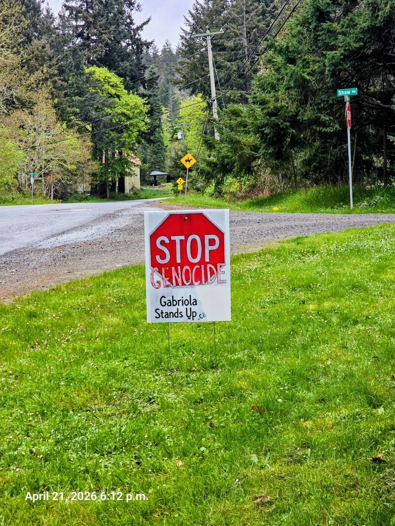 Stop Genocide sign at the corner of South Road and Shaw Road, near the Gabriola Community Centre