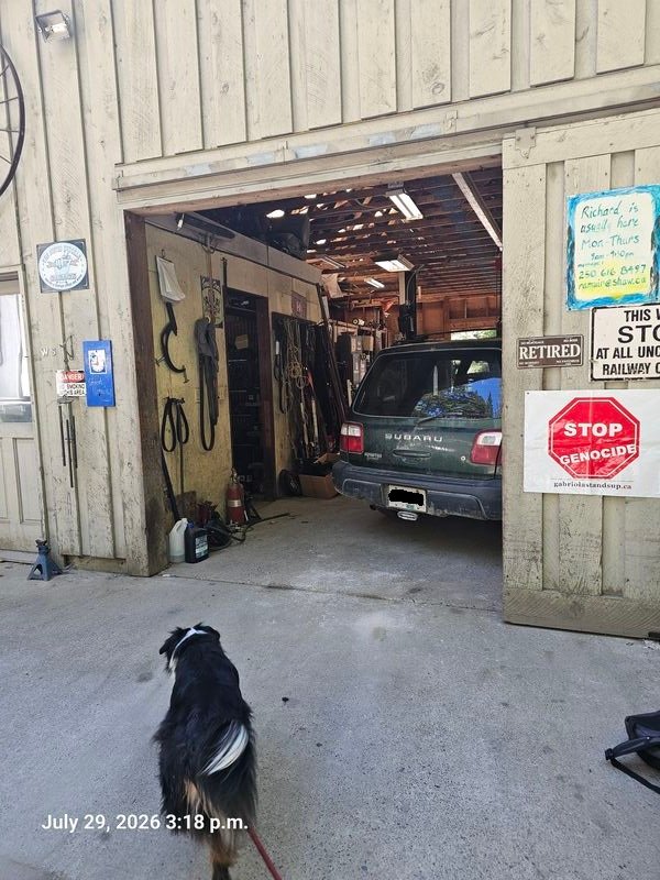 Wayne and Richard's Stop Genocide sign at Busted Knuckle Garage, Gabriola - sign #107